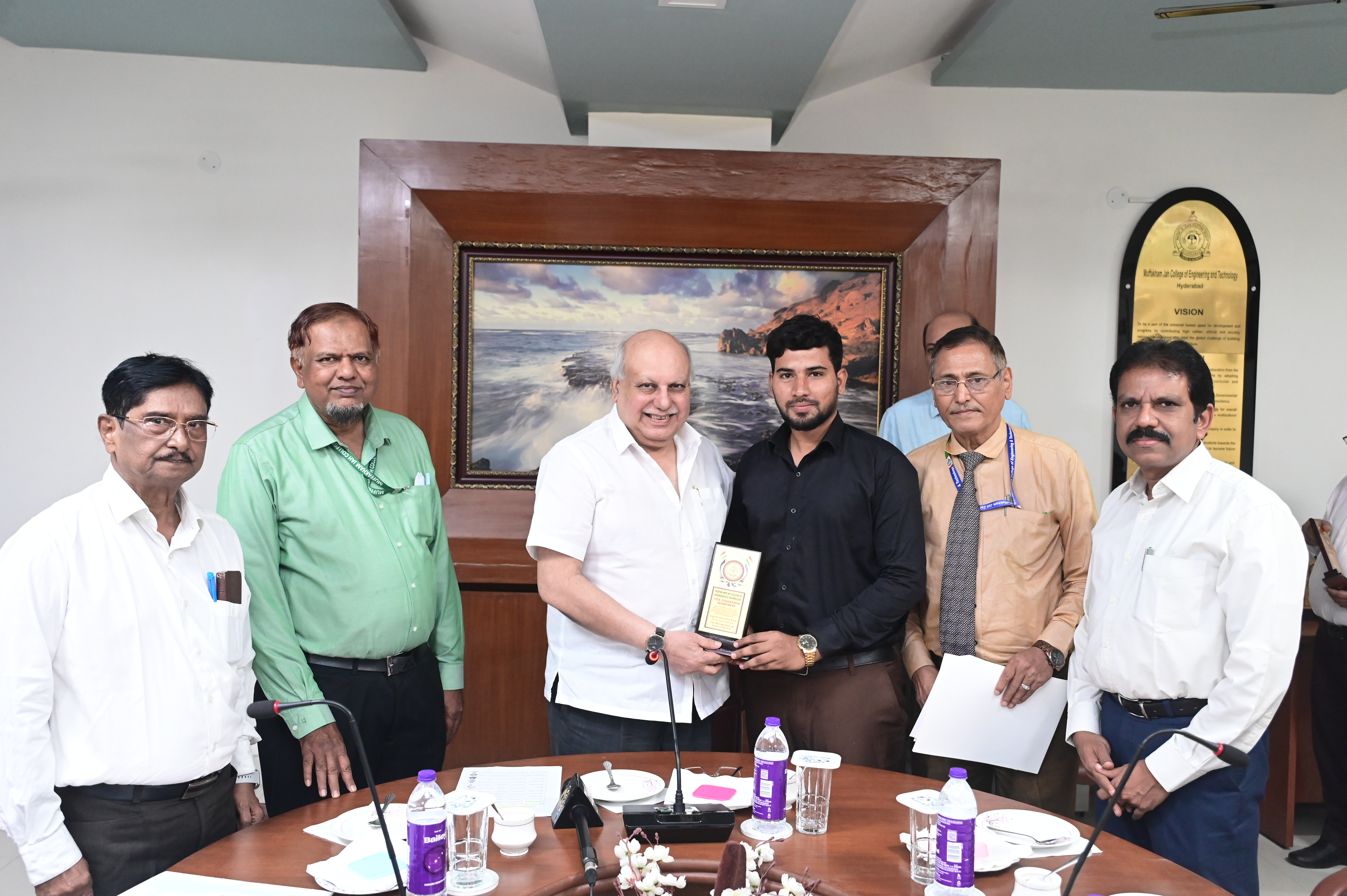 Mr. Syed Shah Irfan, JTO receiving memento from Hon. Secretary Janab Zafar Javeed, SUES